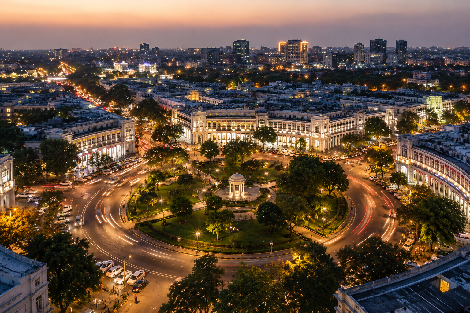 Aerial evening view of Connaught Place Delhi with illuminated colonial architecture, circular roads, and city skyline at dusk 